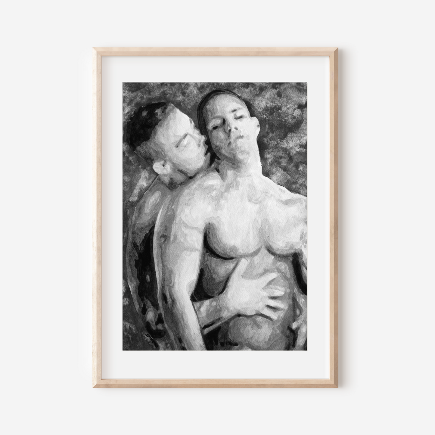 Framed black and white artwork of two nude figures on a white wall