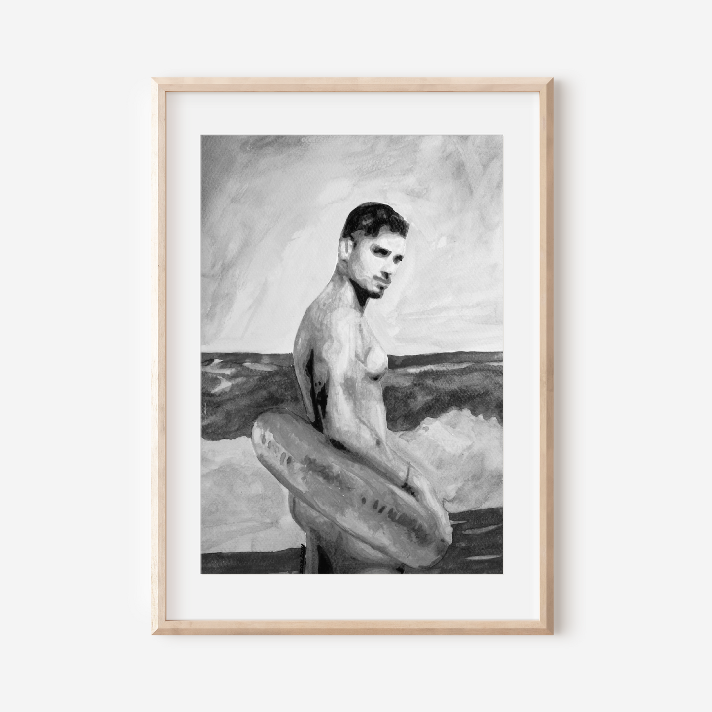 Framed black and white artwork of a man with a surfboard on a white wall