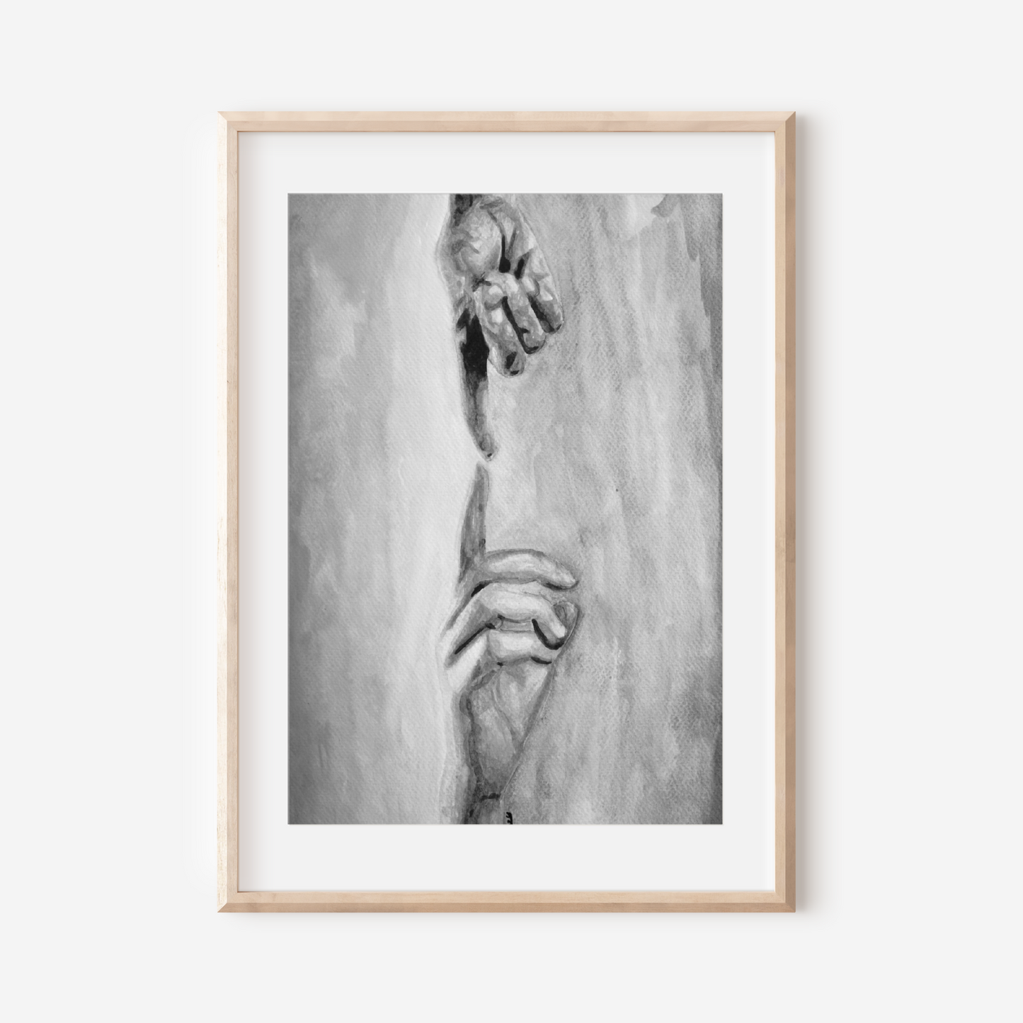 Framed black and white artwork of a hand on a white wall