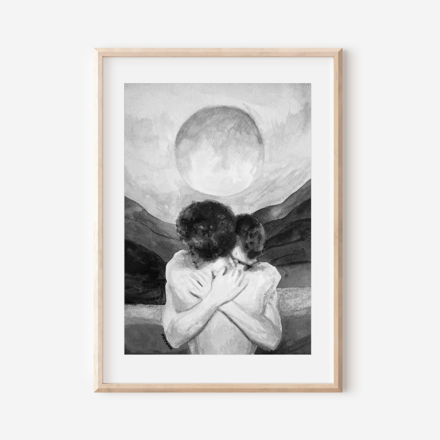 Framed artwork of two people embracing with a large moon in the sky on a white wall.