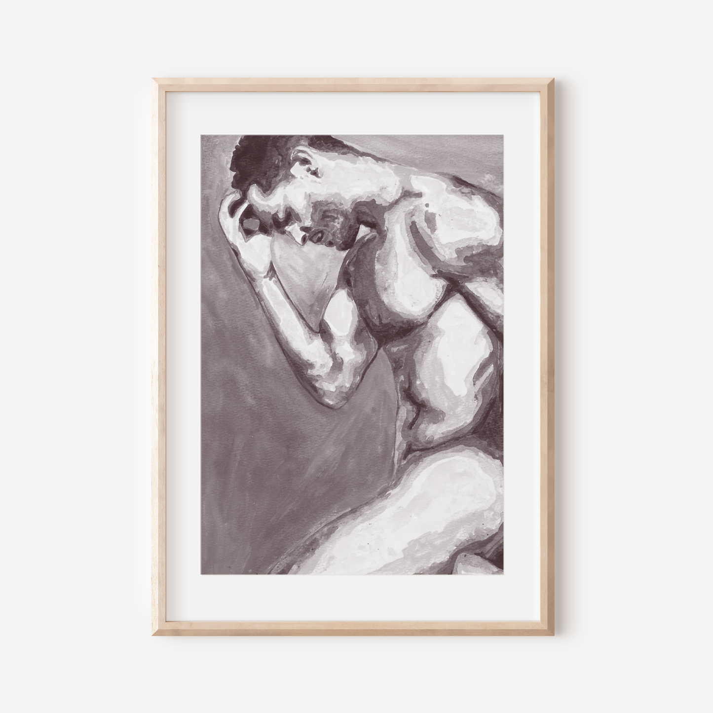 Framed black and white artwork of a nude figure on a white wall