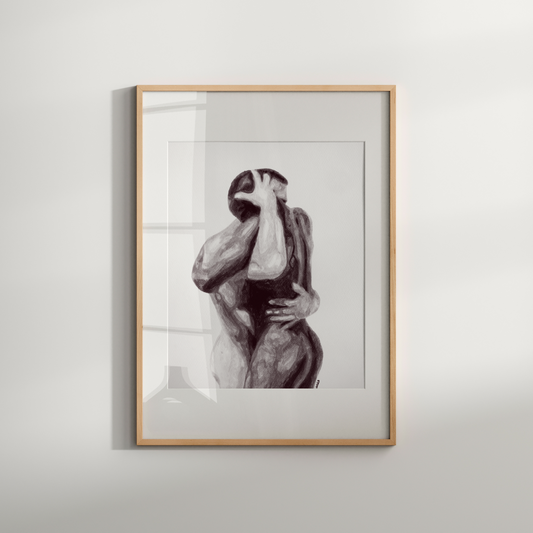 Framed black and white artwork of a nude figure on a light gray wall.