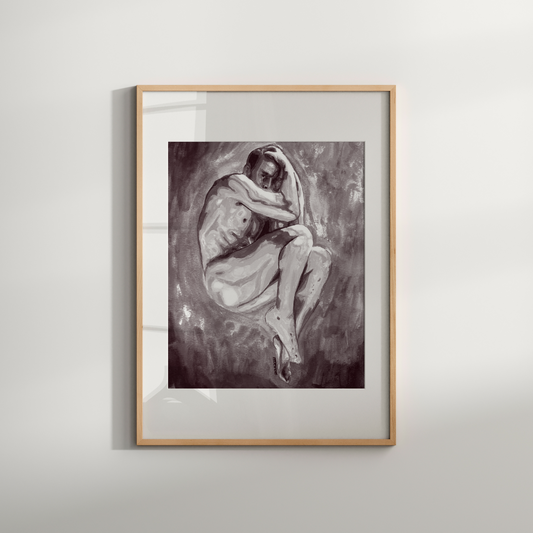 Framed artwork of two people embracing on a white wall