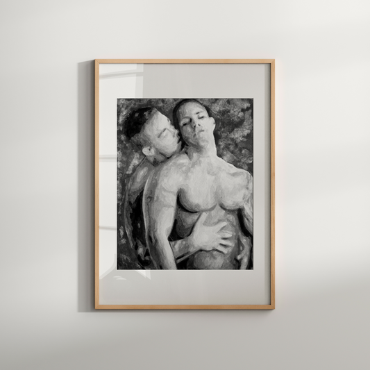 Framed black and white artwork of two people embracing on a light gray wall.