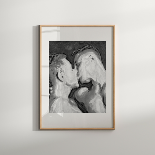 Framed black and white artwork of two people kissing on a light gray wall.