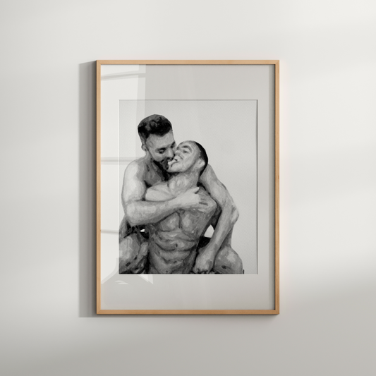 Framed black and white photograph of two people embracing on a light gray background