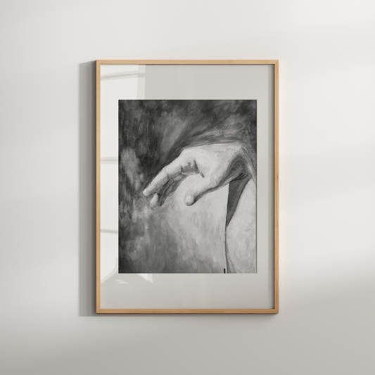 Framed black and white artwork of a hand on a neutral background