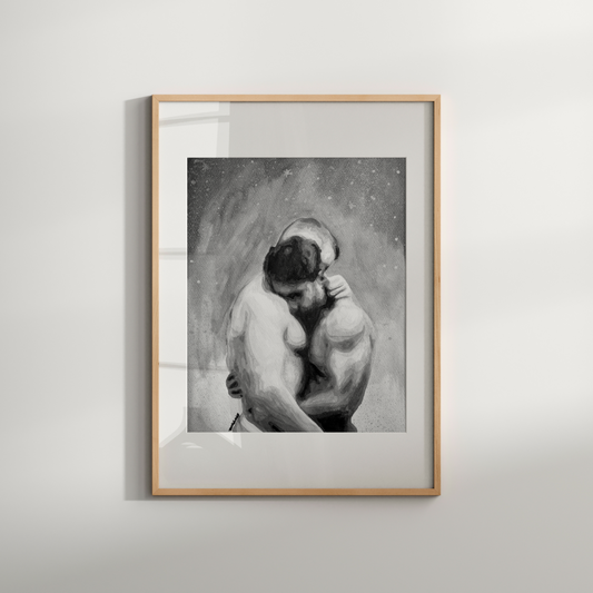 Framed black and white artwork of a couple embracing on a light gray wall.