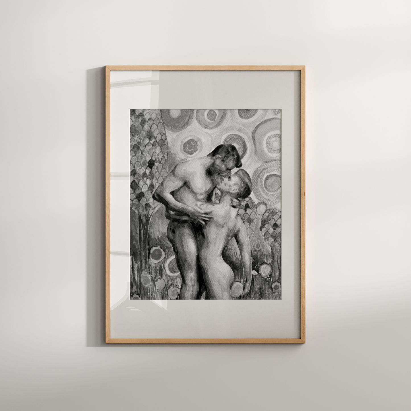 Framed artwork of two nude figures embracing on a light gray background