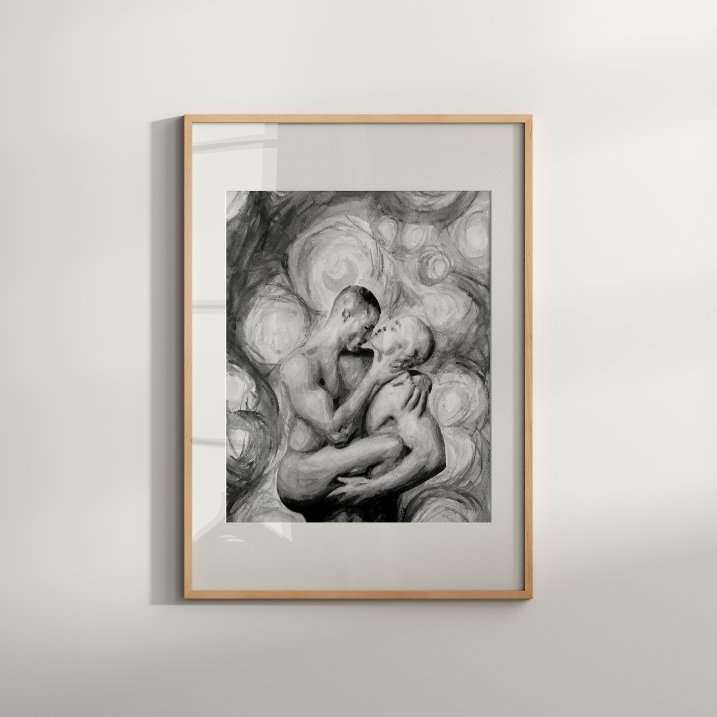 Framed artwork of two figures embracing on a light gray background