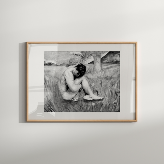 Framed black and white artwork of a nude figure in a field on a light gray wall.