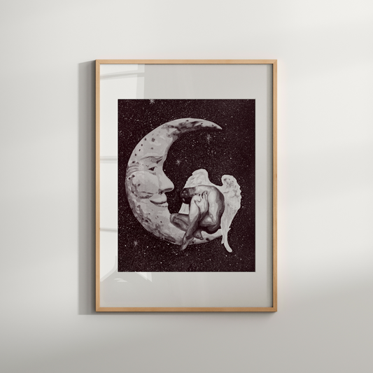 Framed artwork of an angel and moon on a white wall