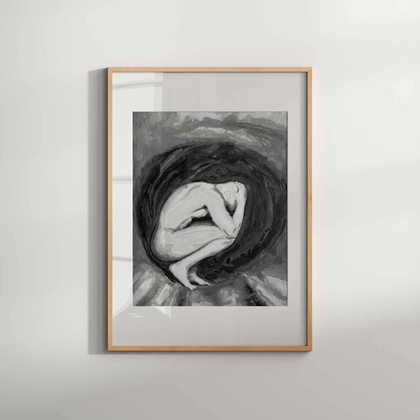 Framed black and white artwork of a woman with flowing hair on a light gray wall.
