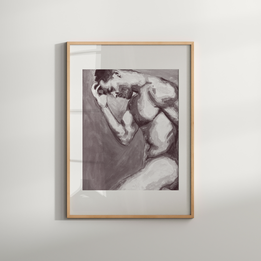 Framed artwork of a nude figure on a white wall