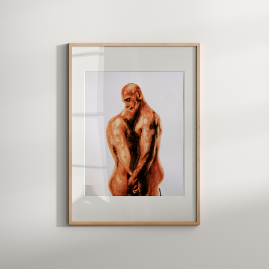 Framed artwork of a nude figure on a white wall