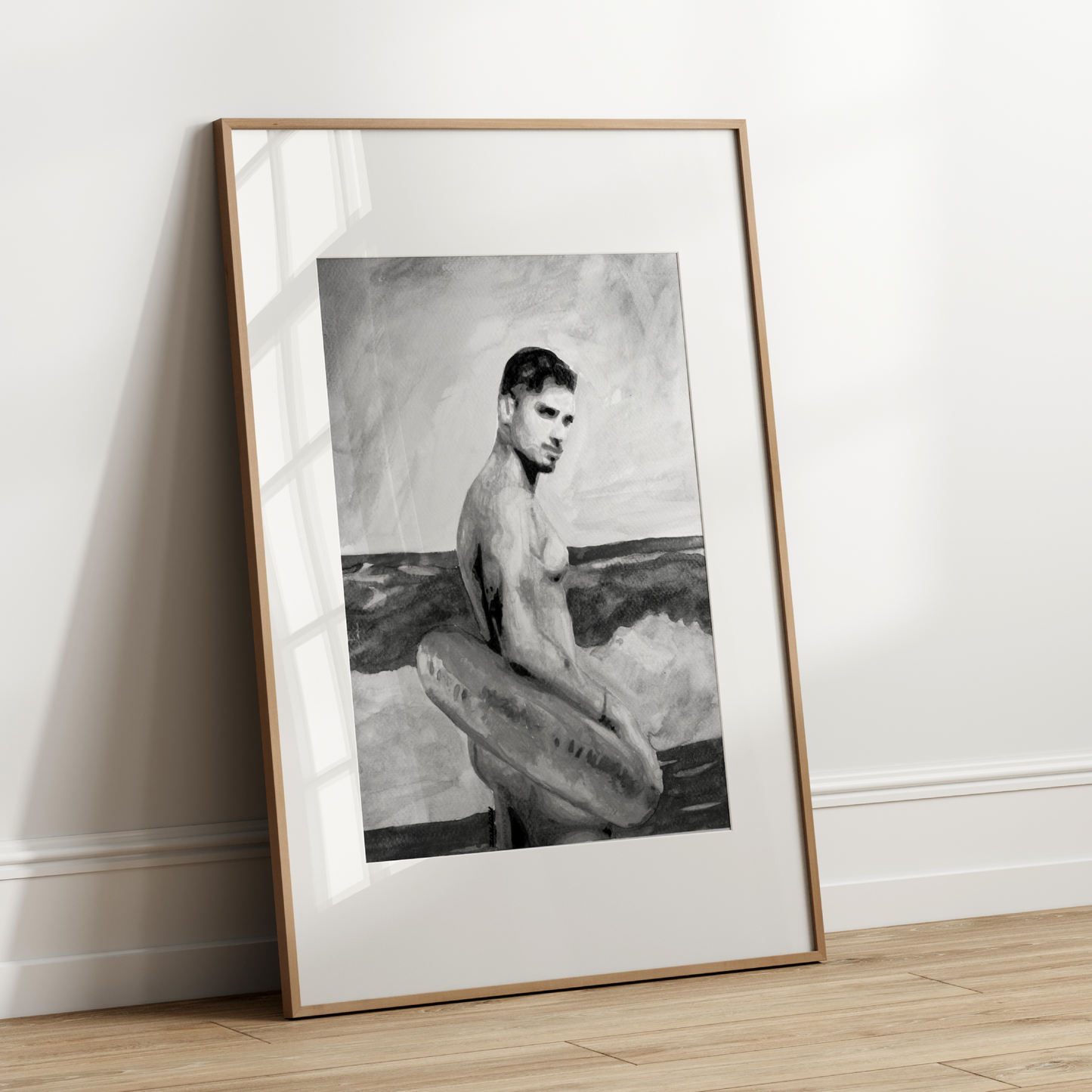 Framed black and white artwork of a man holding a surfboard against a white wall.