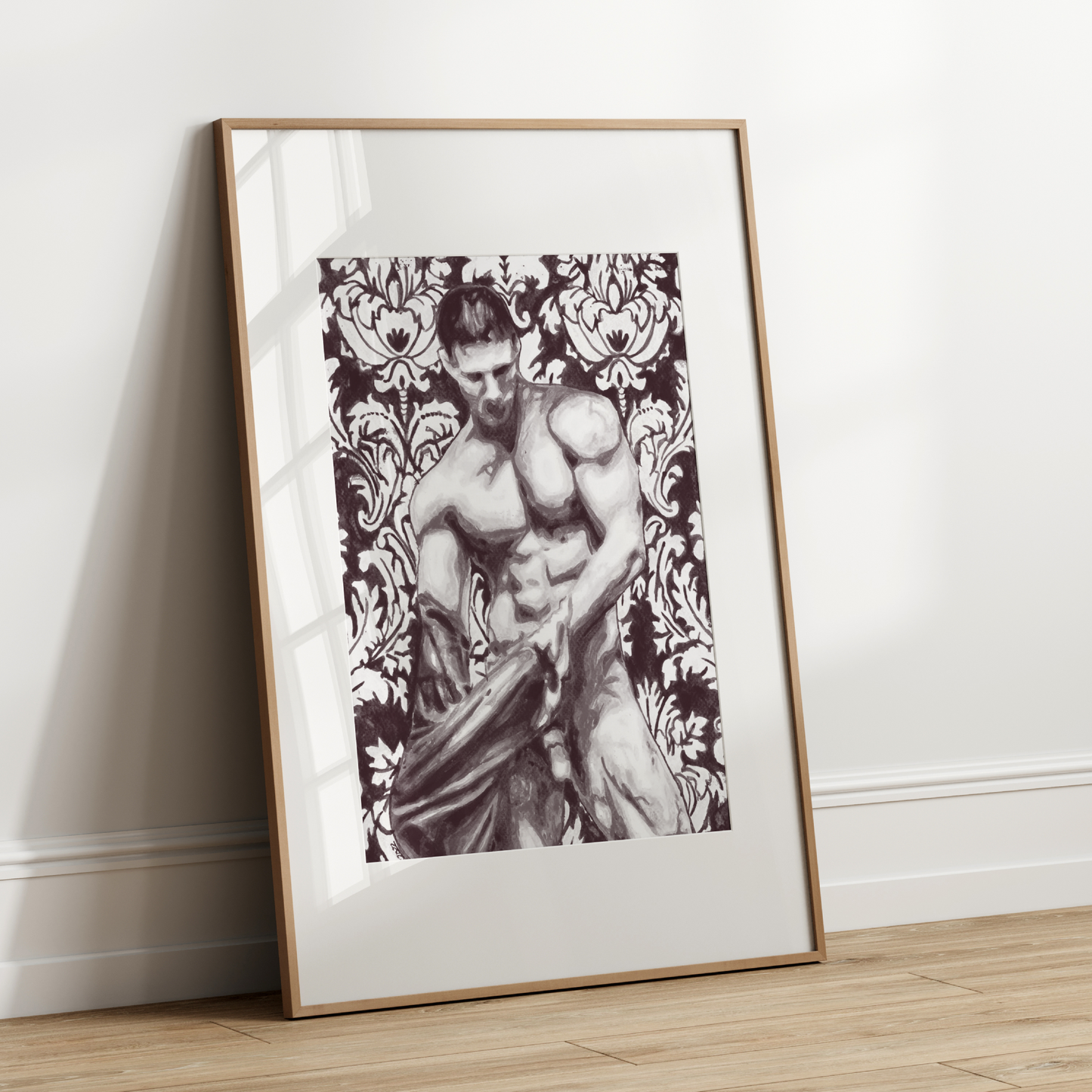 Framed artwork of a shirtless man against a decorative patterned background on a white wall.
