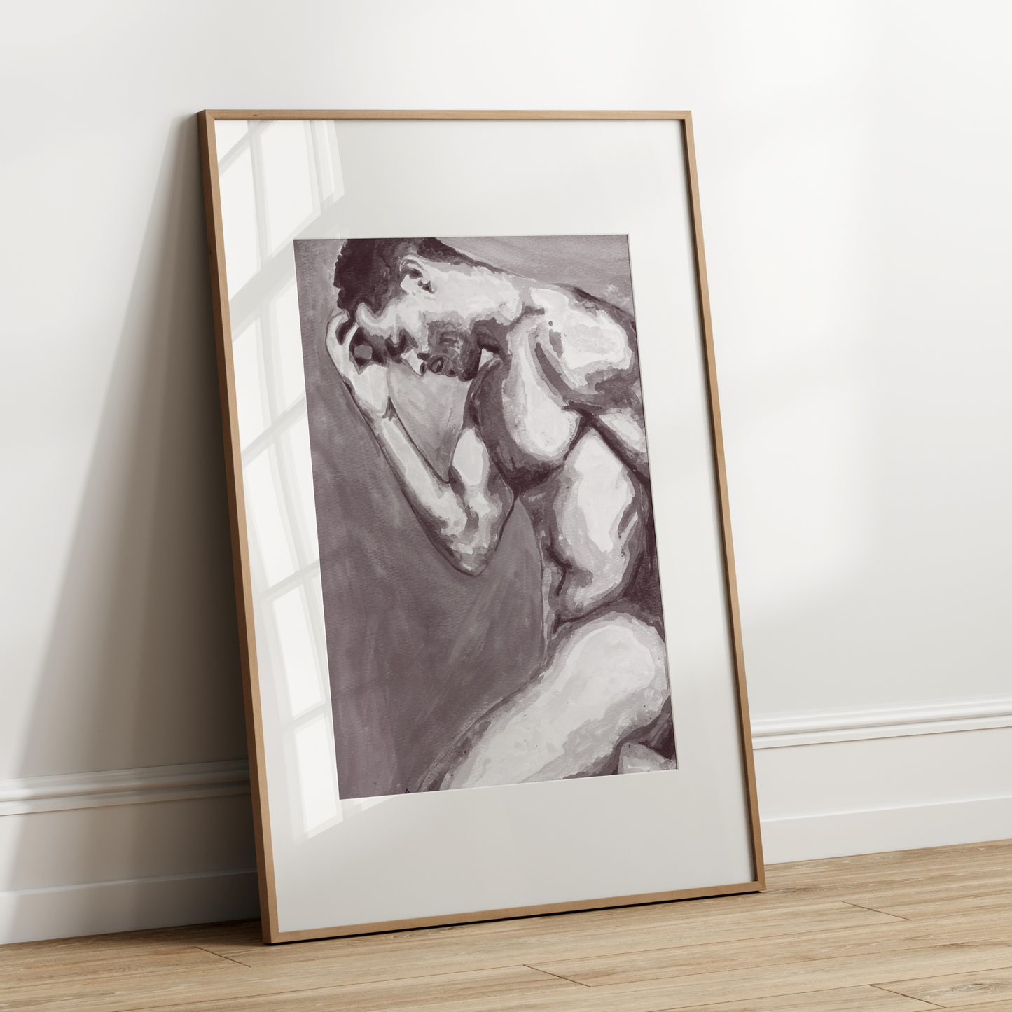 Framed artwork of a nude figure leaning against a wall on a wooden floor.