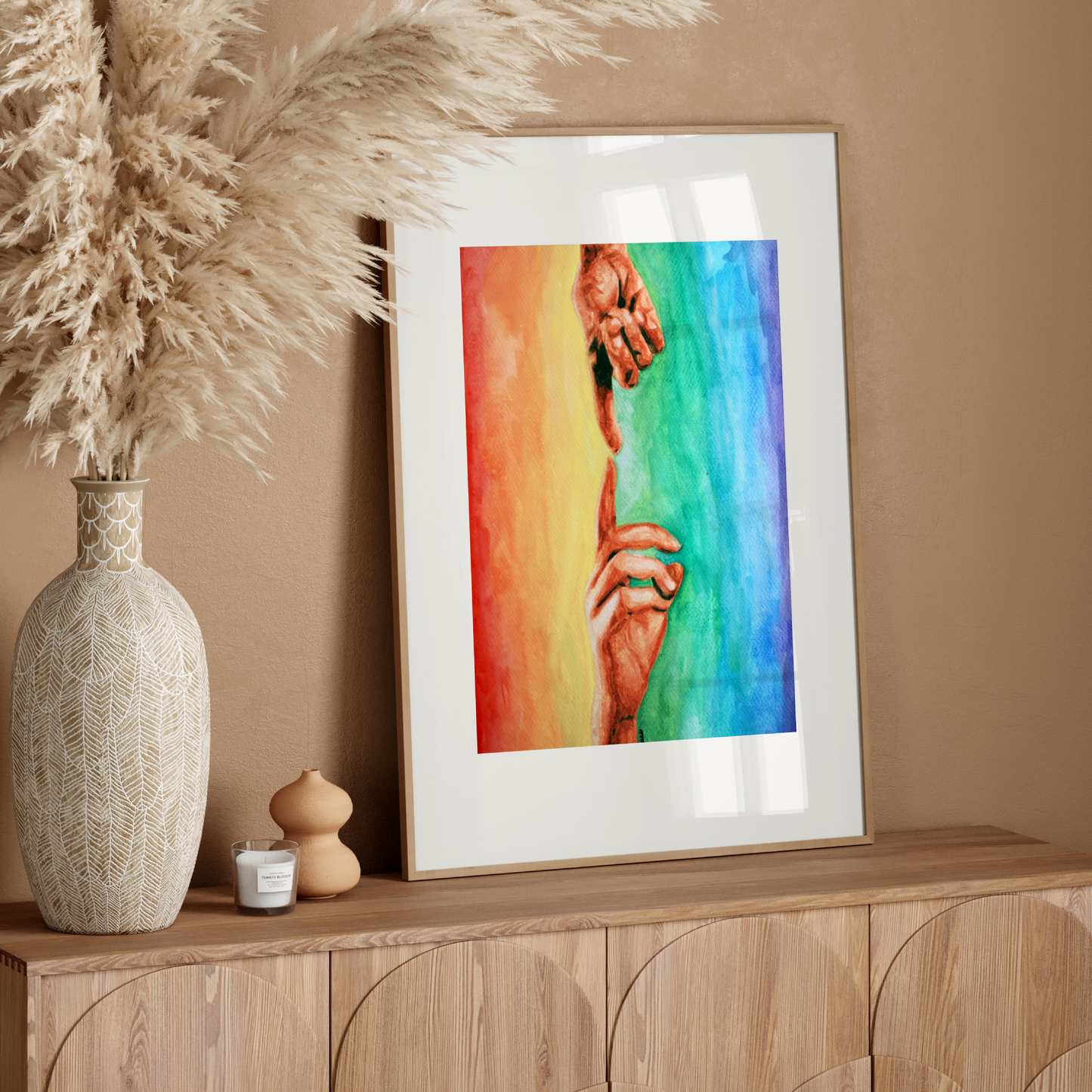 Framed colorful artwork on a wooden sideboard with decorative elements.