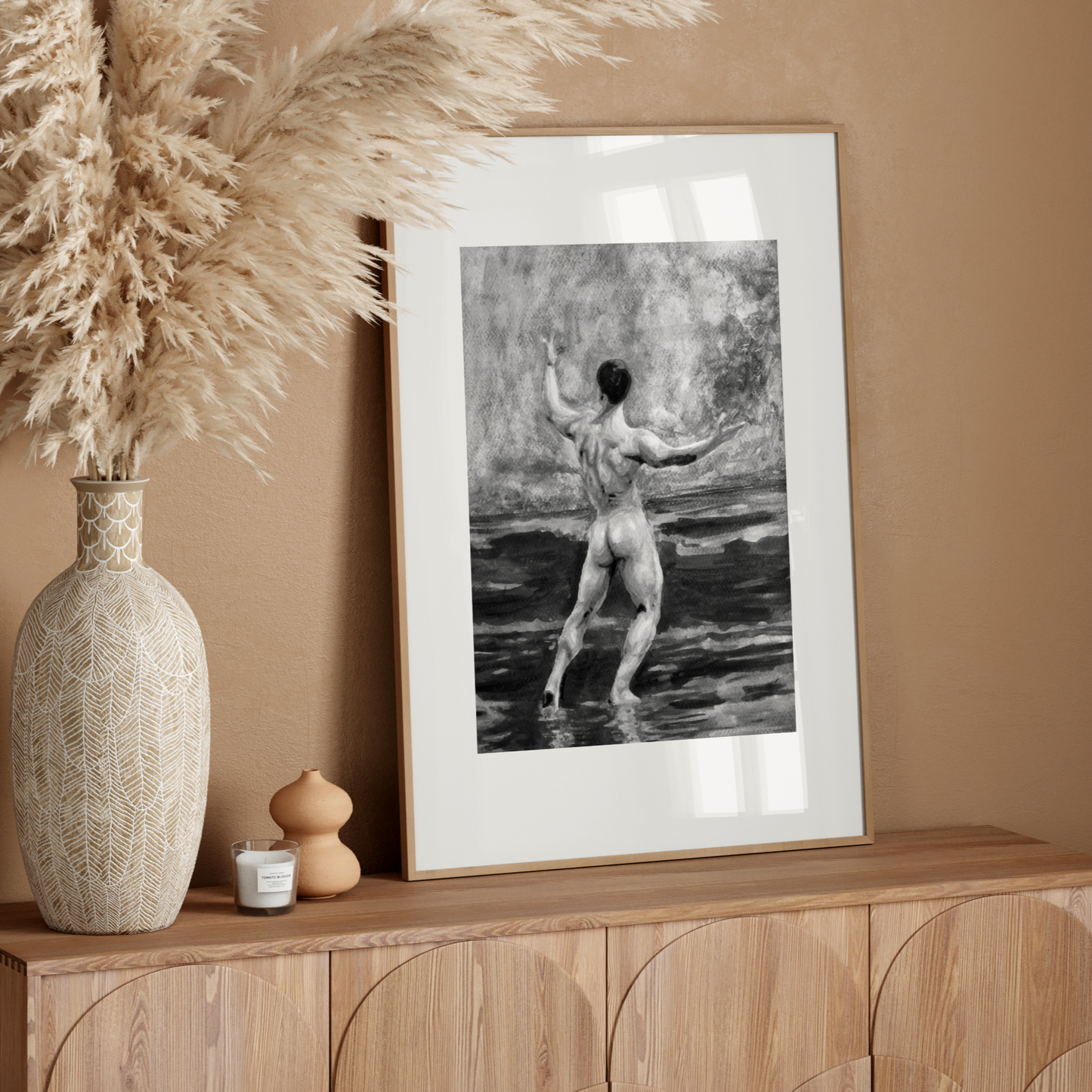 Framed artwork of a nude figure on a wooden sideboard with decorative elements.