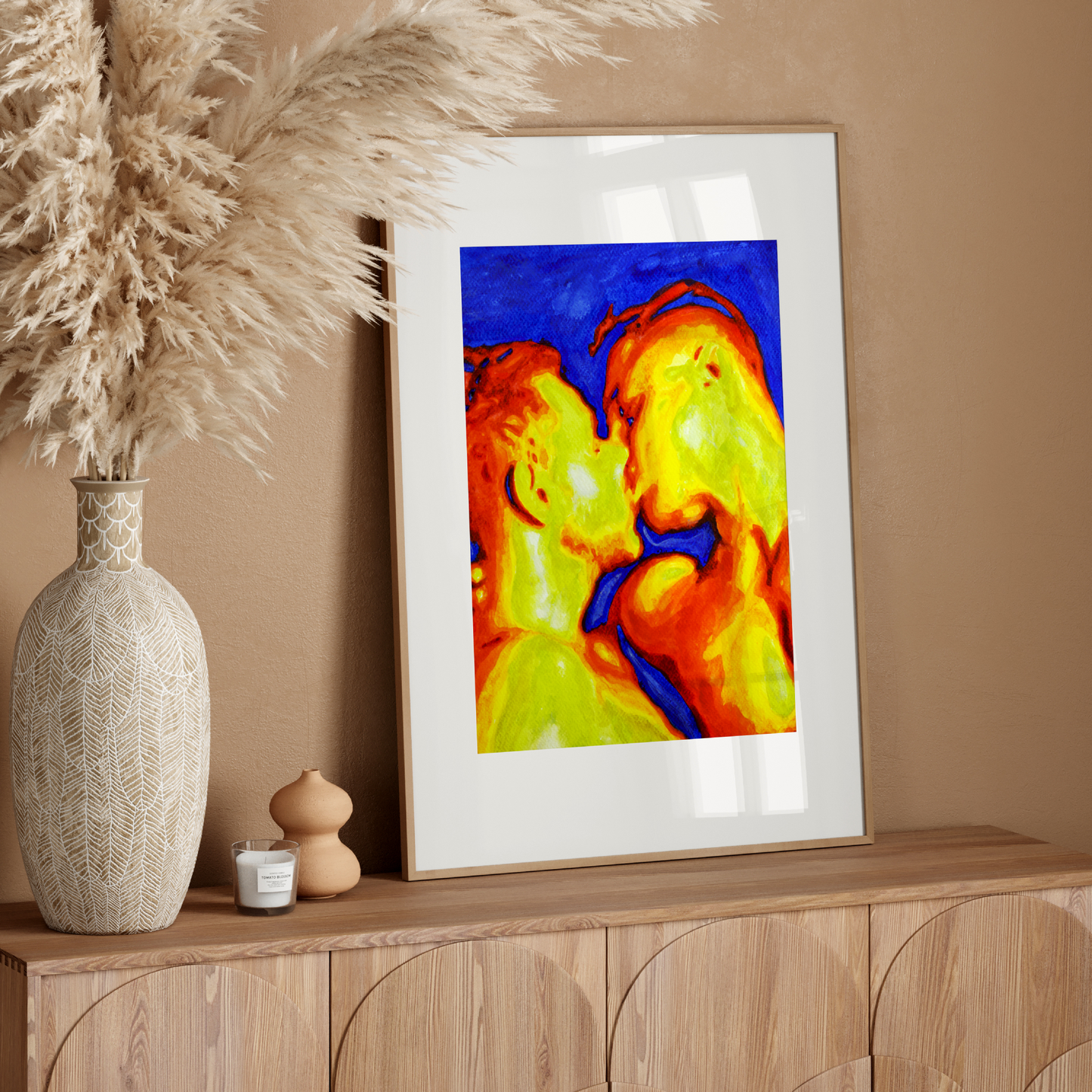 Framed abstract art on a wooden console table with decorative elements.