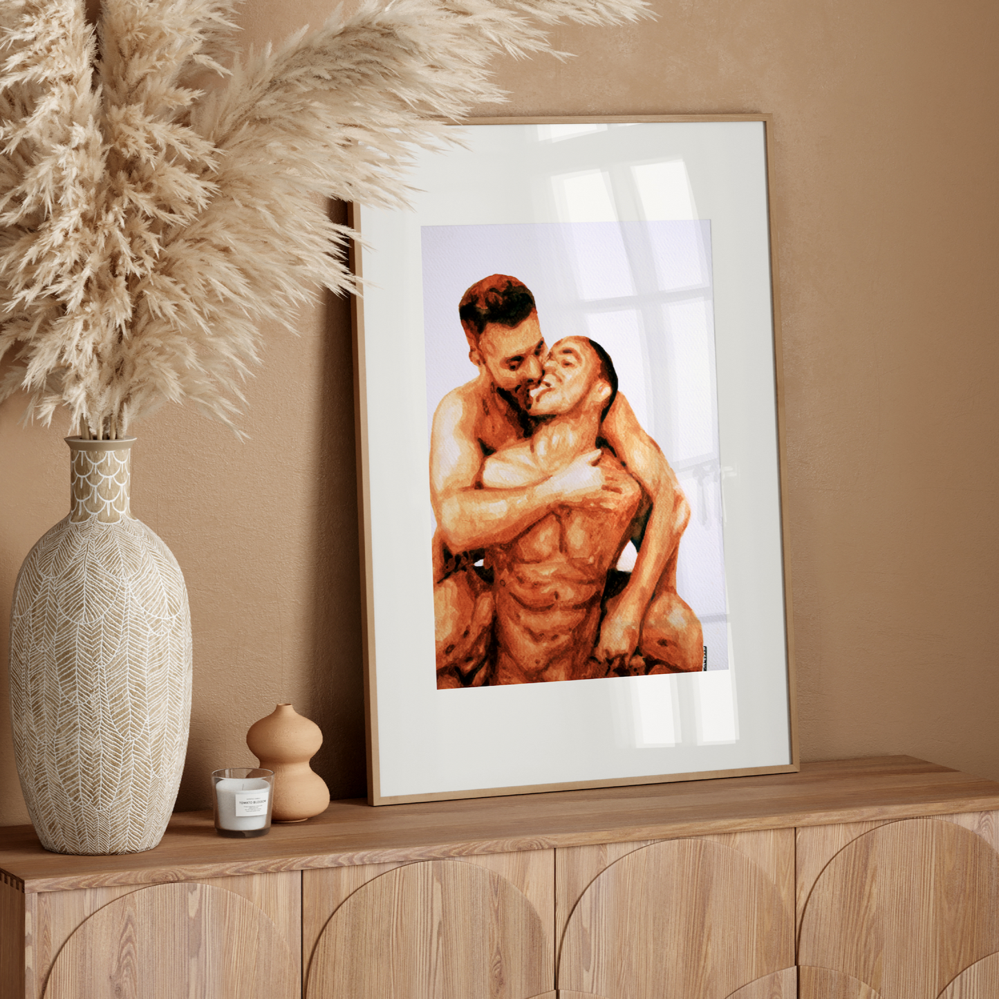 Framed artwork of two people embracing on a wooden console table with decorative elements.