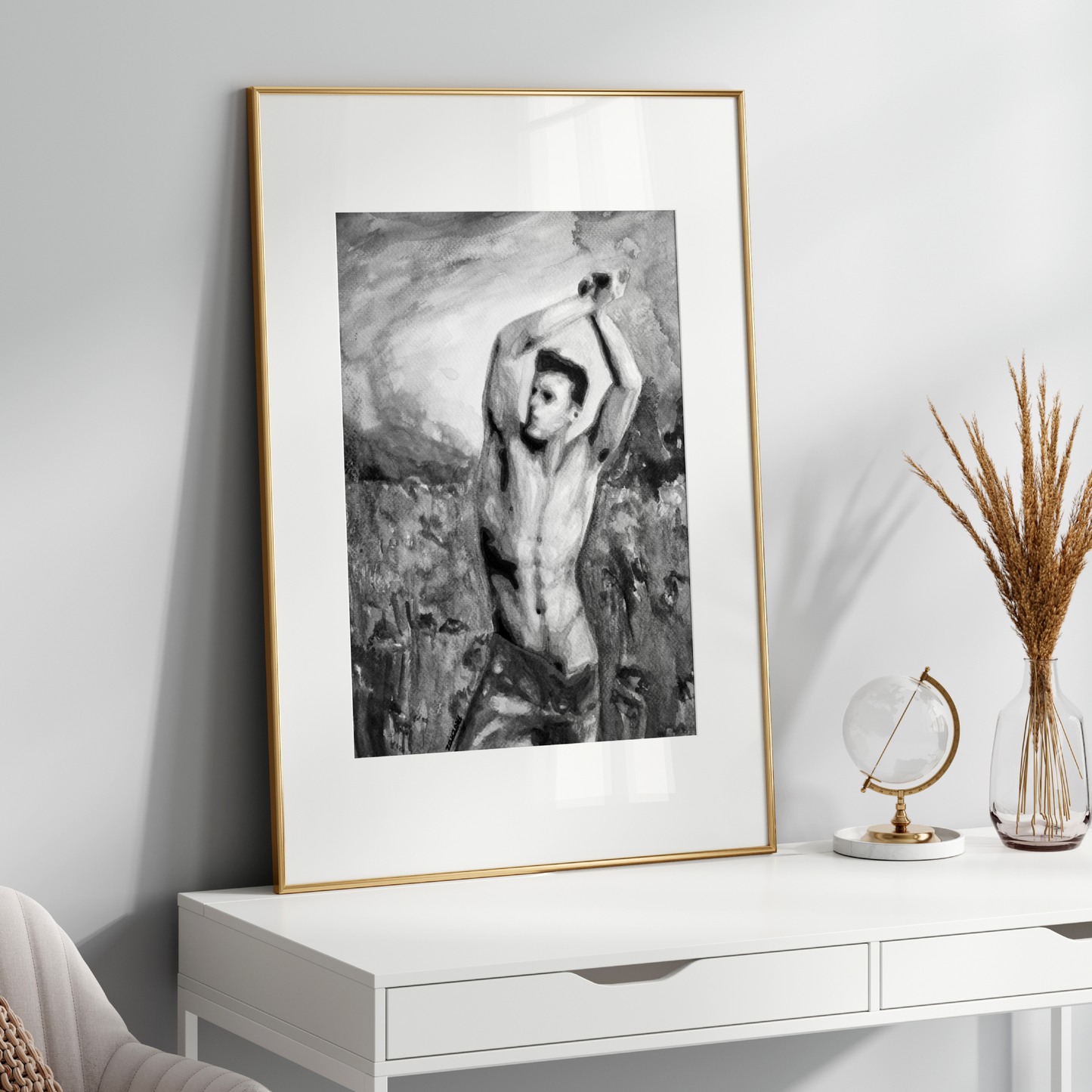 Framed black and white artwork on a white wall above a white console table with decorative items.