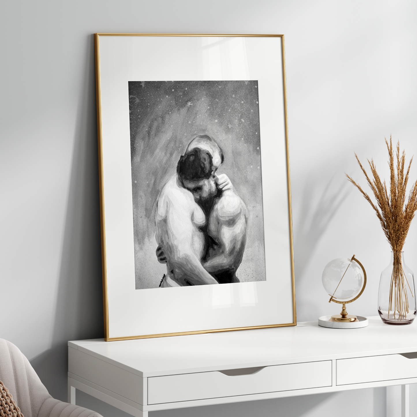 Framed black and white artwork on a white wall above a white console table with decorative items.