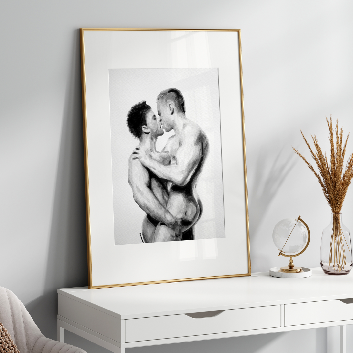 Framed black and white artwork of two people embracing on a white console table.