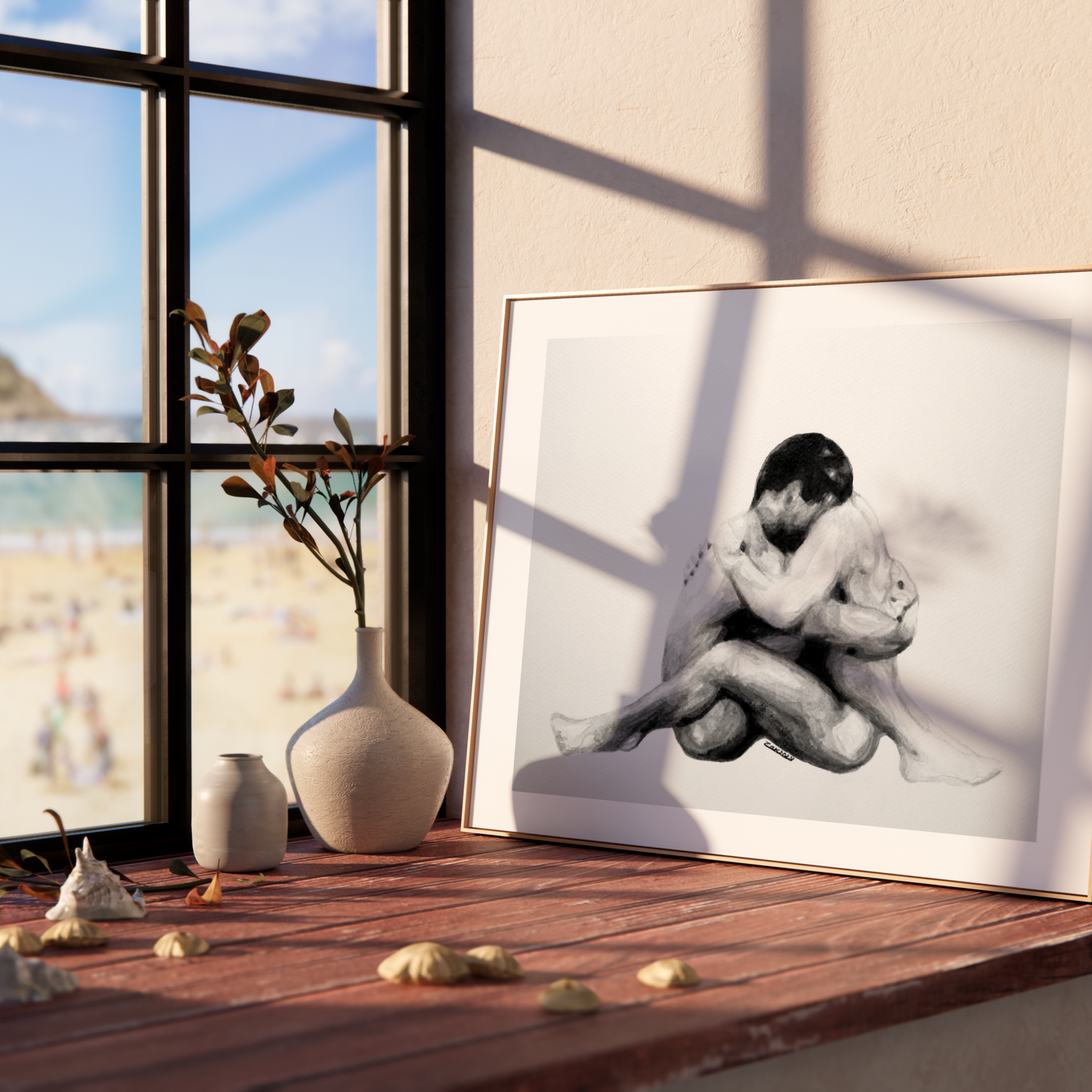 Framed black and white artwork of a couple embracing on a wooden shelf with a window view.