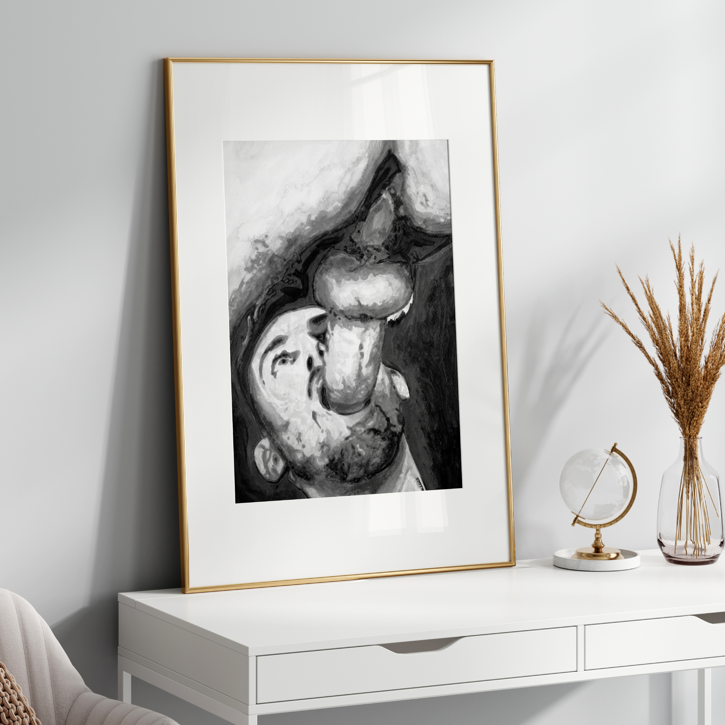 Framed black and white artwork on a white wall above a white console table.