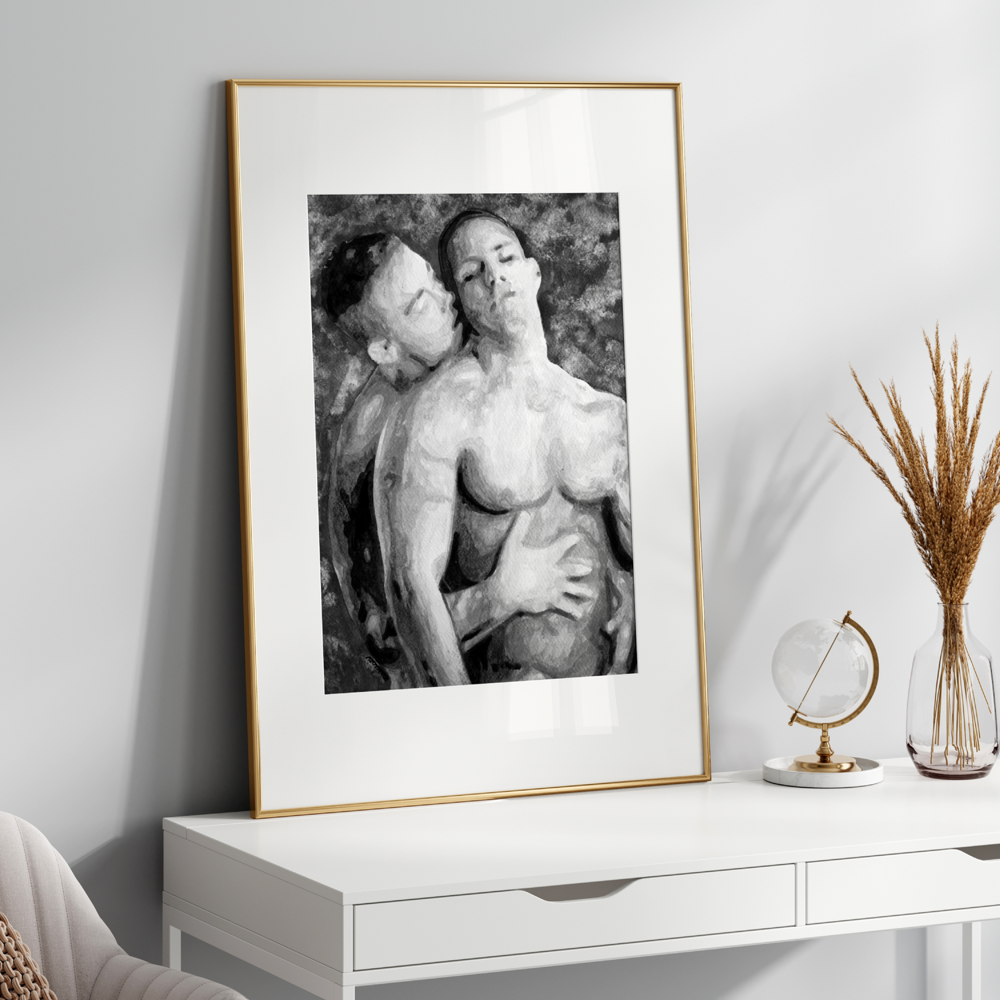 Framed black and white artwork of a nude figure on a white console table with decorative items.