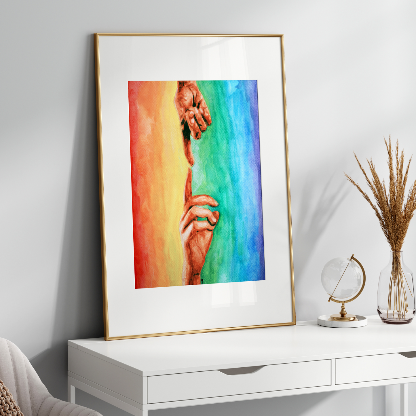 Framed colorful artwork on a white wall above a white console table.