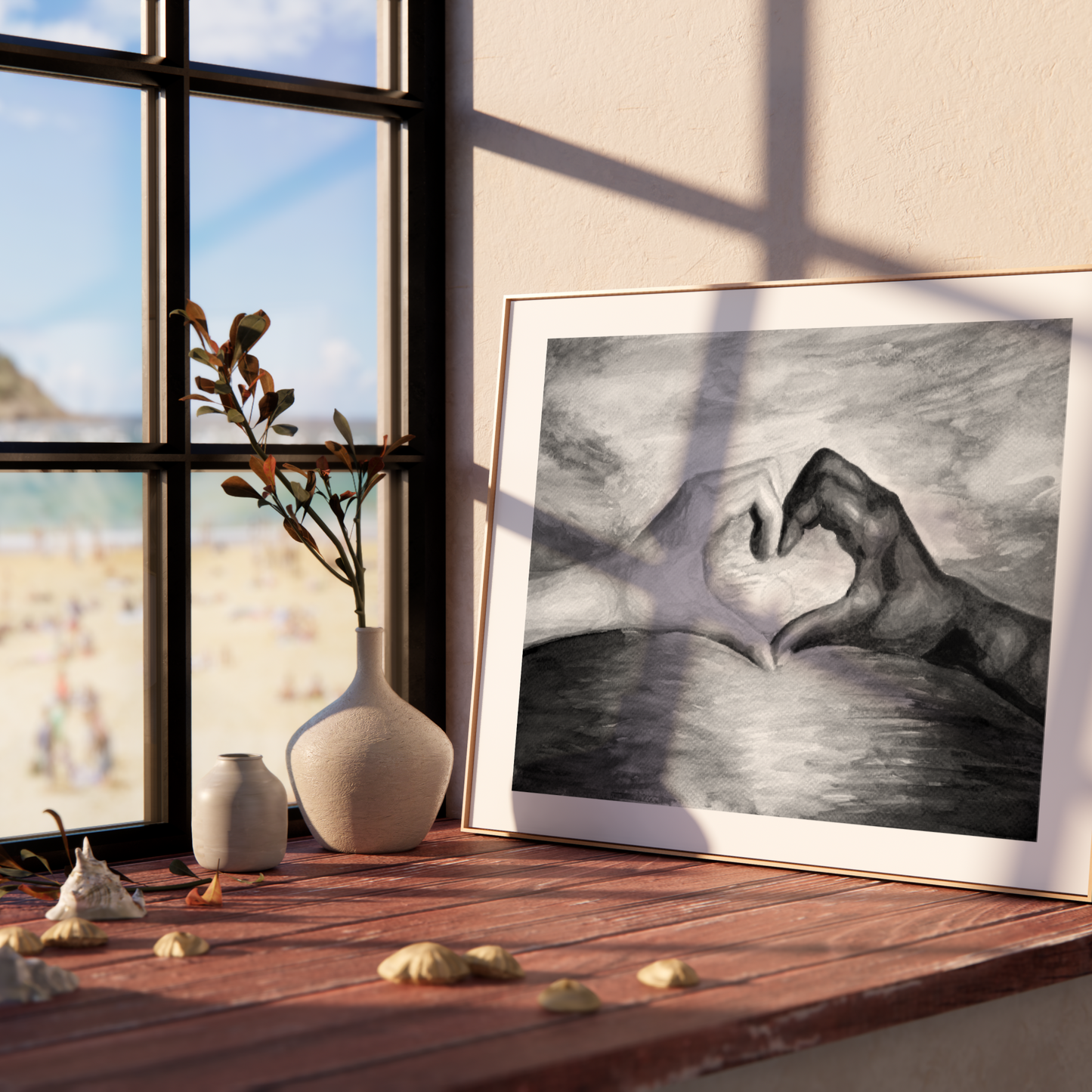 Framed artwork of two hands forming a heart shape on a wooden shelf with a window view.