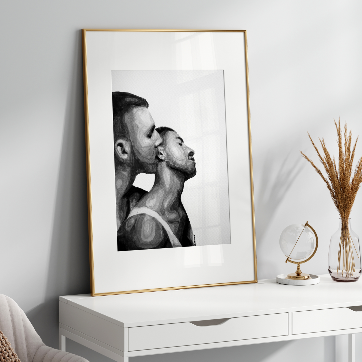 Framed black and white portrait on a white wall above a white console table.
