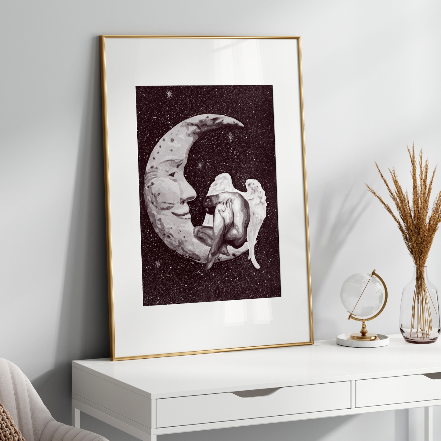 Framed artwork of a moon and a person on a white shelf with decorative items.