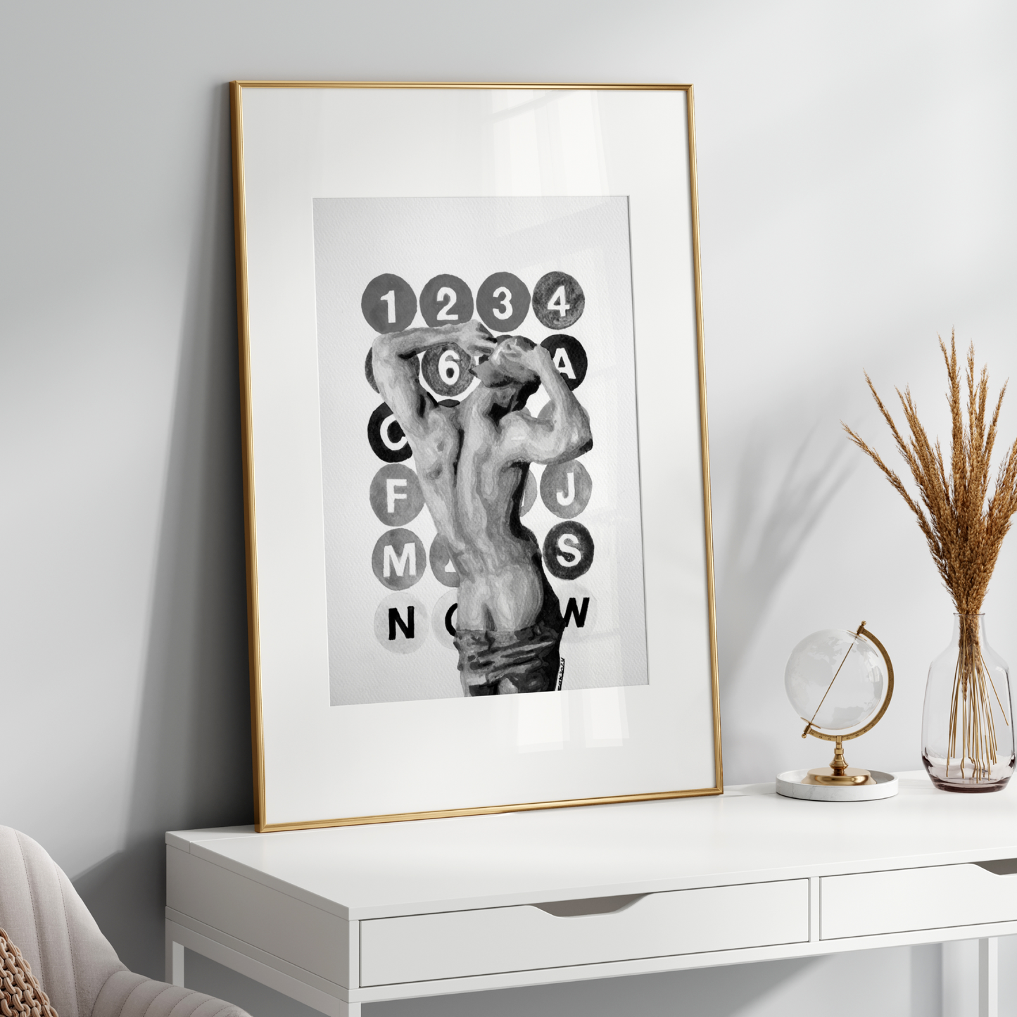 Framed artwork on a white wall above a white console table with decorative items.