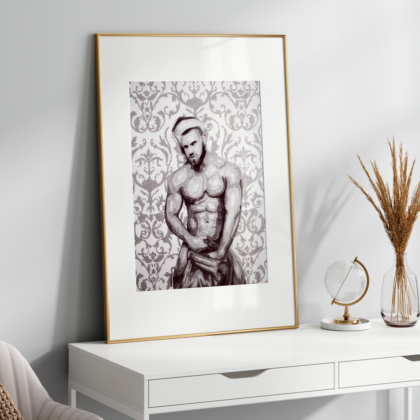 Framed artwork of a shirtless man on a white console table with decorative items.