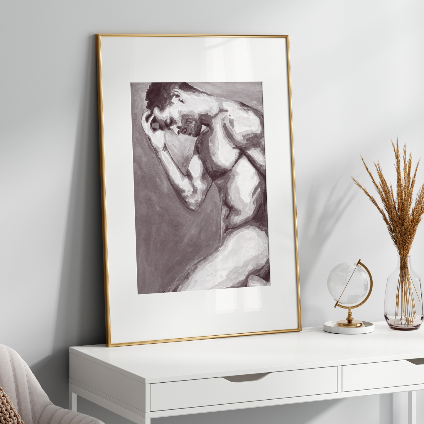 Framed black and white artwork on a white wall above a white console table with decorative items.