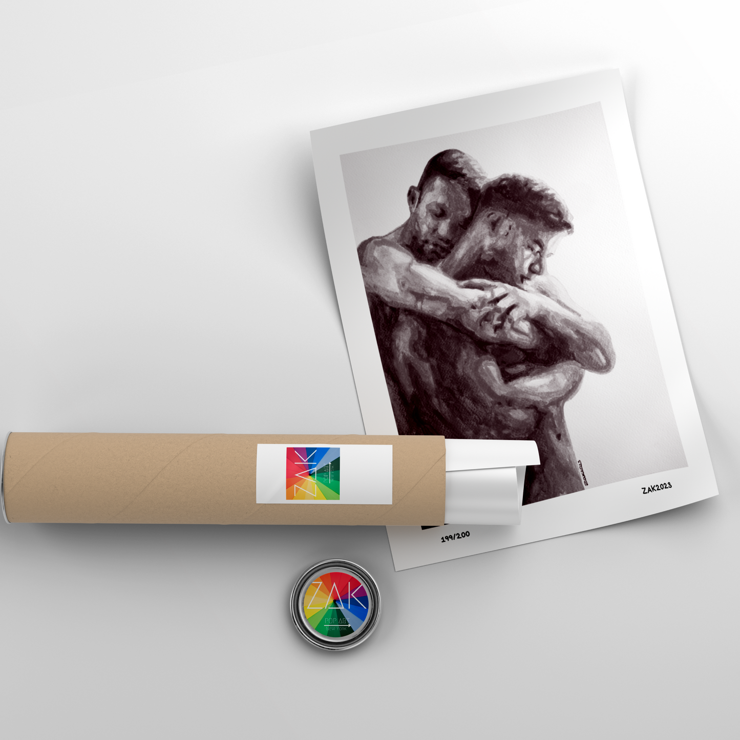 A black and white print of a same-sex couple embracing, framed in a light wood frame.