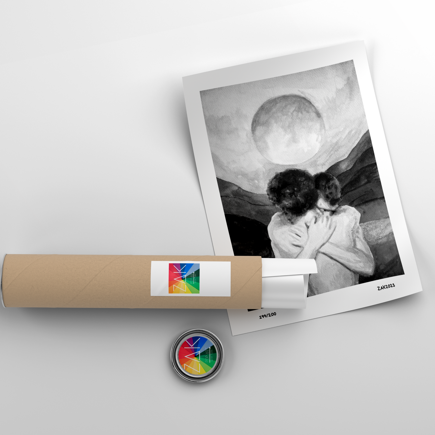 Framed black and white photo of a couple embracing, with a cylindrical product and colorful wheel in the foreground on a light gray background.
