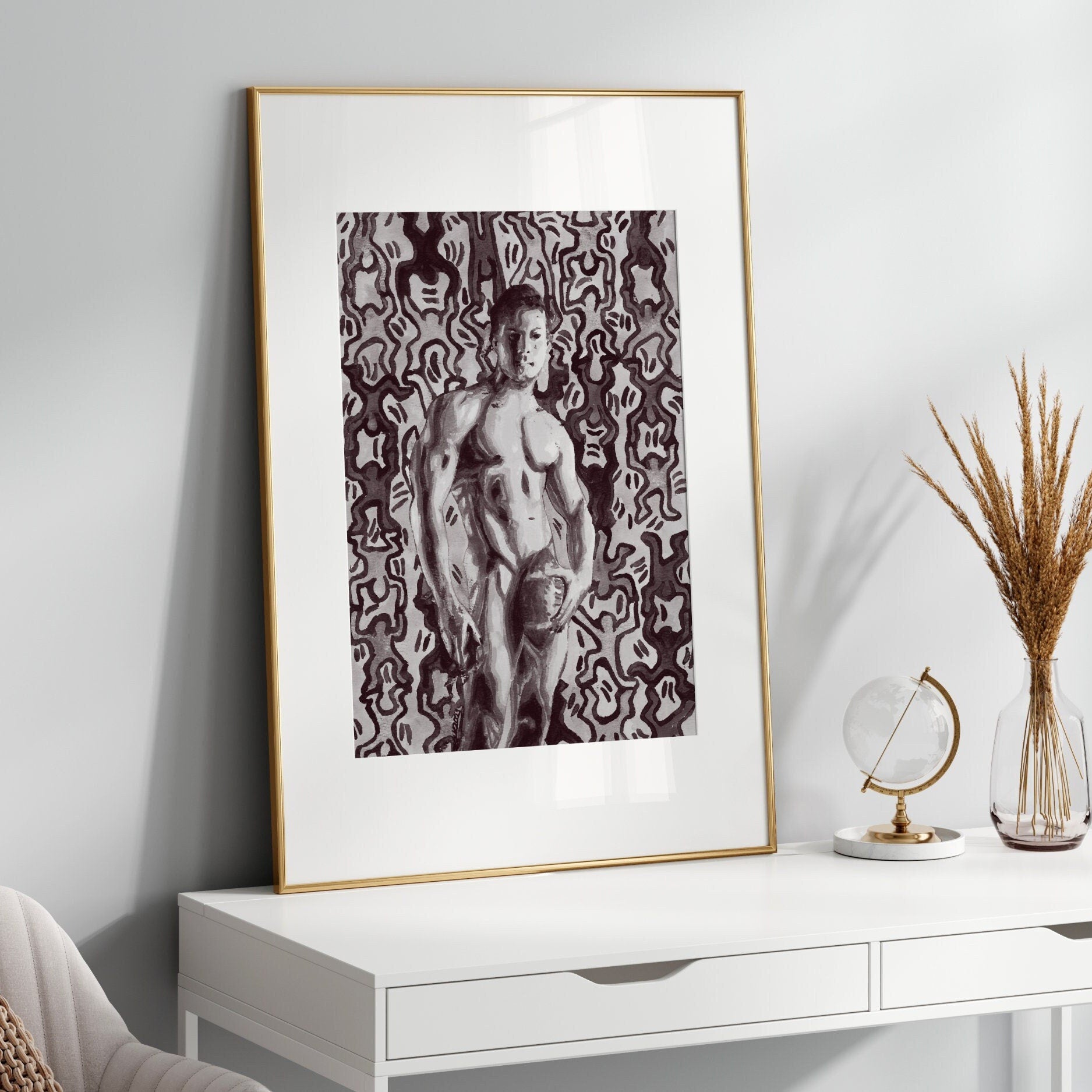 This image features a striking black and white art print of a painting by Keith Haring, presented in a simple, elegant frame. The artwork captures a male figure in a provocative pose, set against a patterned background that enhances the visual drama of the figure.