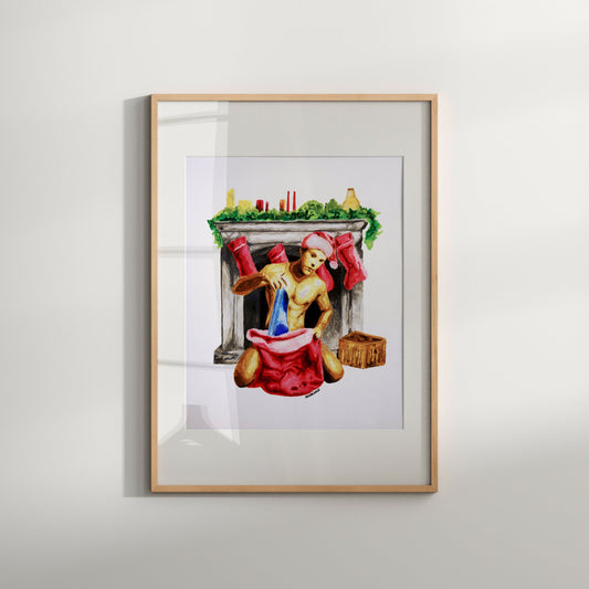 A framed artwork featuring a stylized illustration of Santa Claus sitting in a fireplace, wearing a red suit and a hat, with a Christmas stocking in the foreground.