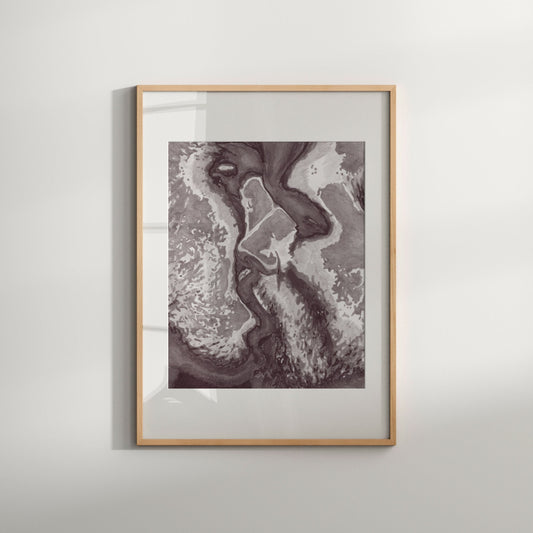 This image features a striking black and white print titled "The Kiss," presented in a simple, elegant frame. The artwork depicts an abstract and poetic representation of homoerotic love, showcasing a blend of dark and light tones that evoke a sense of mystery and passion.