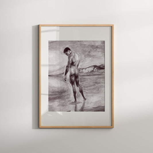 This image features an art print titled "Male on Beach," presented in a classic black frame that contrasts attractively with the artwork. The print depicts a nude male figure, rendered in a soft, warm tone that highlights the contours and muscular tension of the figure against the backdrop of a serene beach scene.