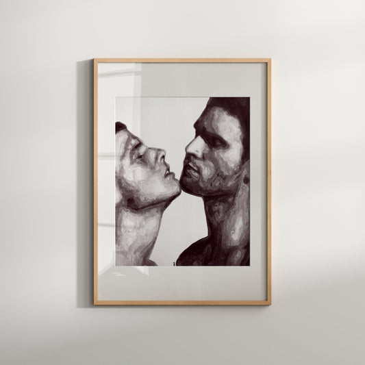 A framed black and white print of a gay couple in an intimate embrace displayed on a wall.
