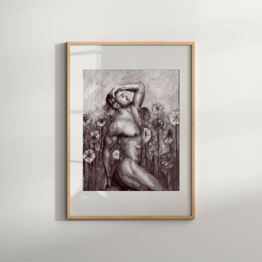 Black and white art print of a nude male figure with a floral background, framed in a light wood frame.