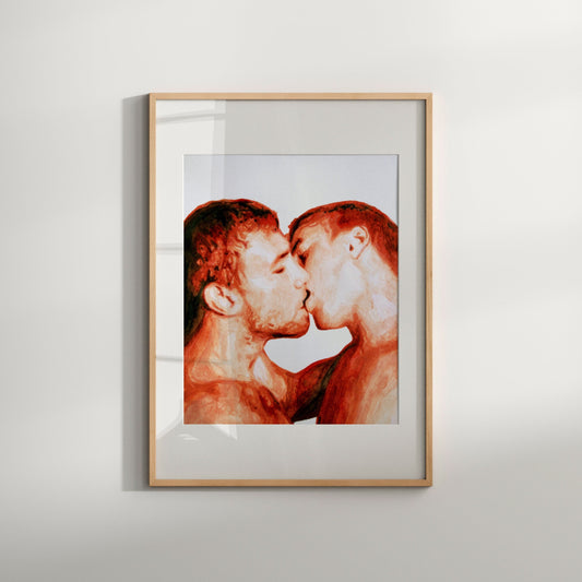 A framed watercolor art print featuring a gay couple kissing, with red and white tones predominating.