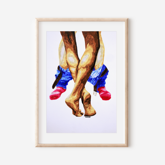 Framed artwork of legs wearing cowboy boots and colorful socks on a white wall.
