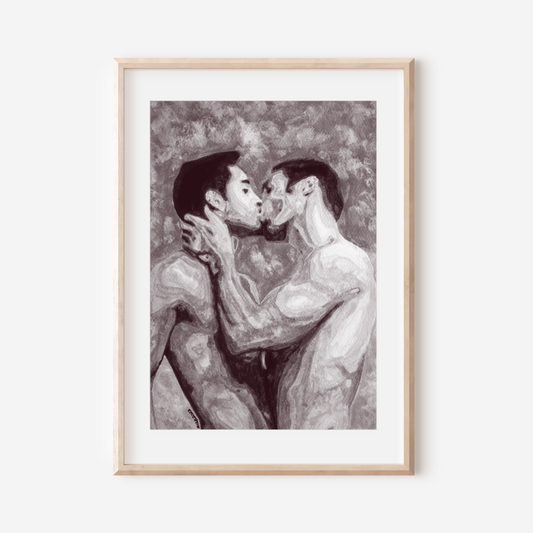 Framed artwork of two people kissing on a white wall